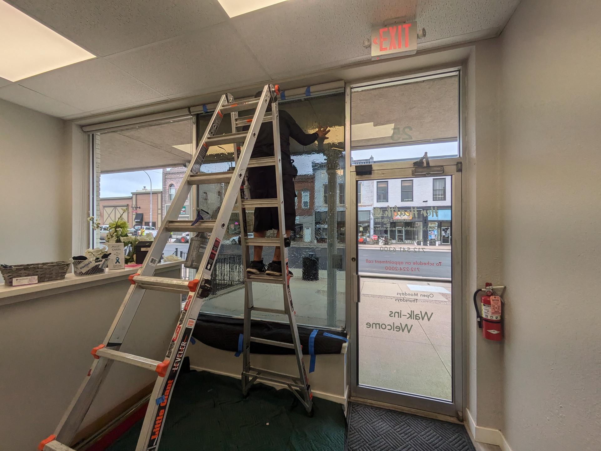 Clinic windows with window film being installed in Le Mars, Iowa