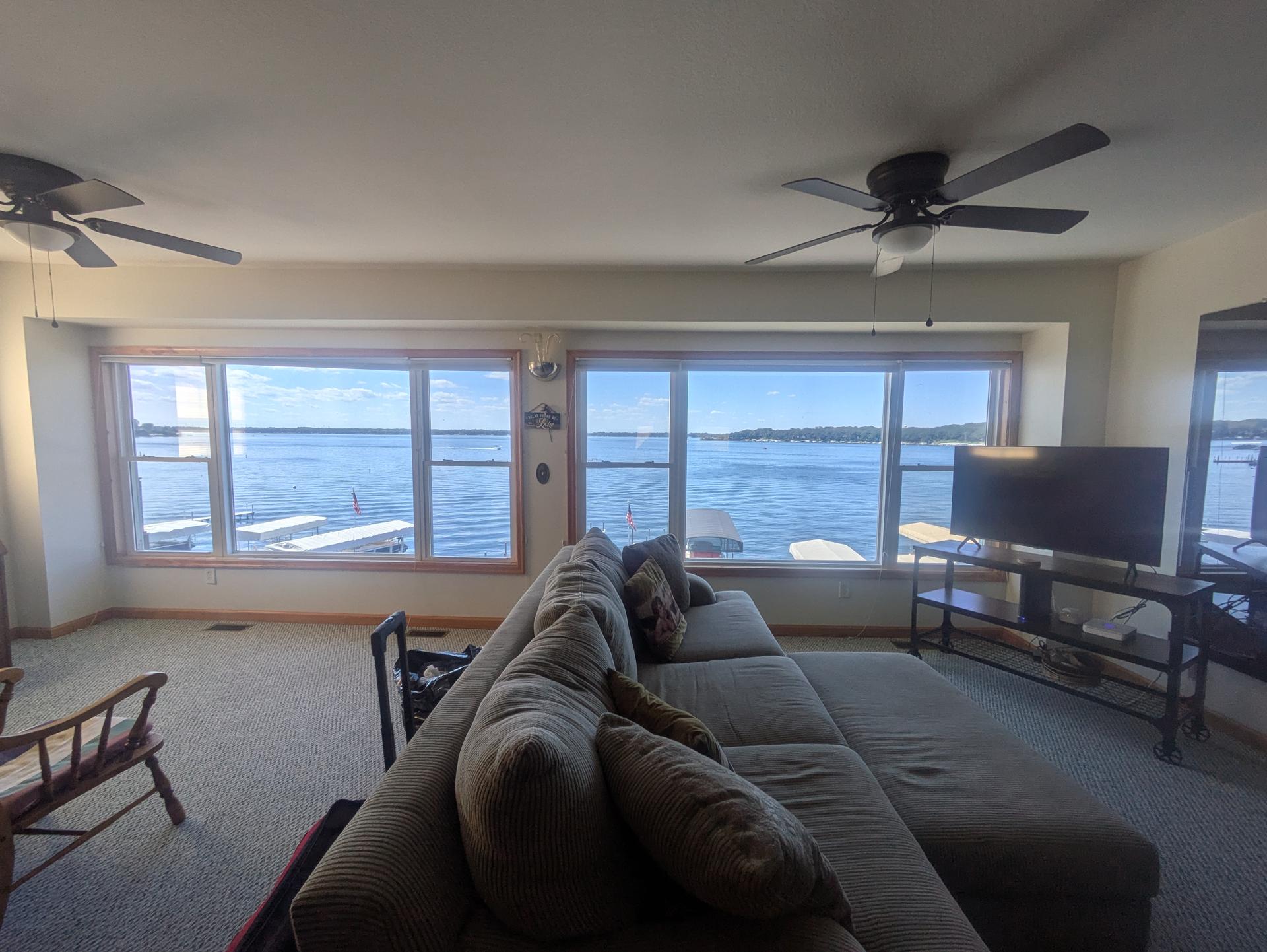 Lake home living room with tall windows and a lake view